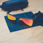 Cross Vision Sunglasses with black frames and red lenses, faith-based accessory