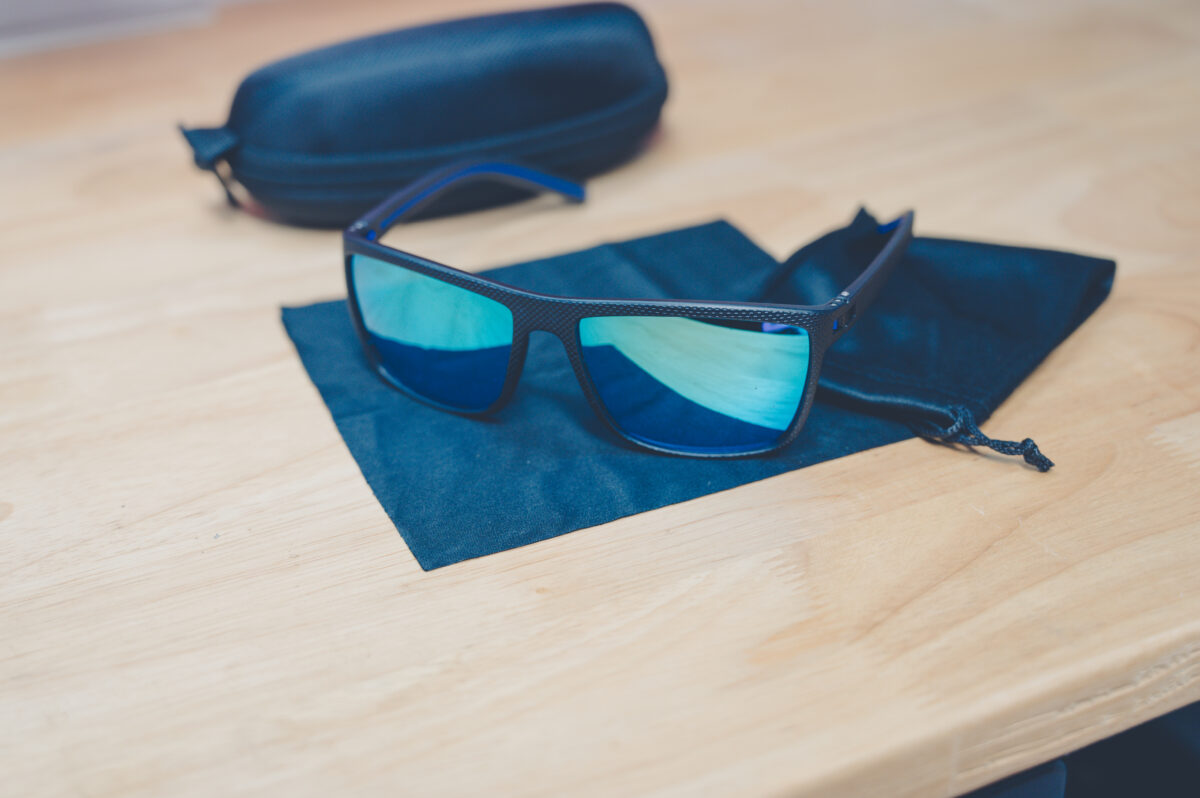 Cross Vision Sunglasses with black frames and blue-green lenses, faith-based accessory