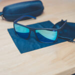 Cross Vision Sunglasses with black frames and blue-green lenses, faith-based accessory
